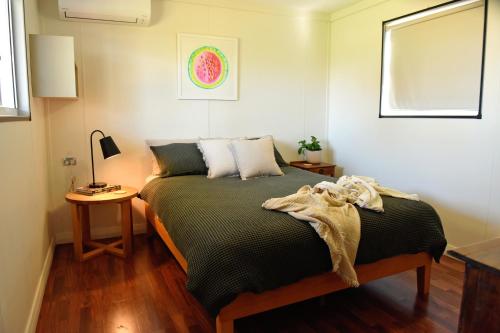 a bedroom with a bed and a table with a lamp at The Jetty Hut - Lake Frontage Barmera Riverland in Barmera