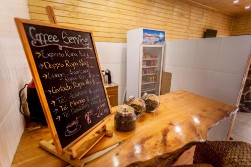 a table with a chalkboard sign in a room at Easter Island Ecolodge in Hanga Roa