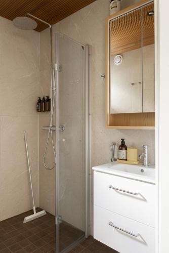 a bathroom with a shower and a sink at Villa MiaEmilia A in Espoo