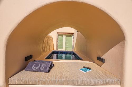 a plunge pool in a house with an archway at Casita Suites in Megalochori