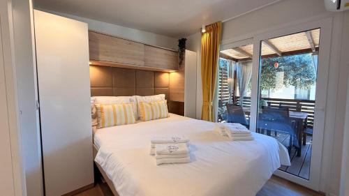a bedroom with a large bed with towels on it at Iris Holiday Homes in Biograd na Moru