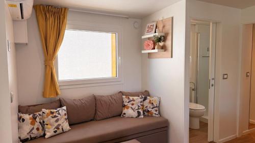 a living room with a couch and a window at Iris Holiday Homes in Biograd na Moru