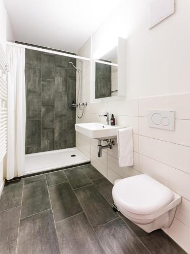 a bathroom with a toilet and a sink at TouchBed in St. Gallen