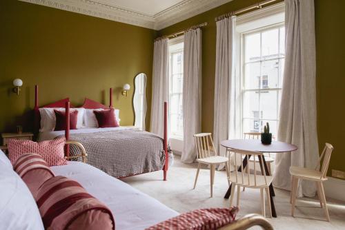 a bedroom with a bed and a table and chairs at Merchant's House in Derry Londonderry