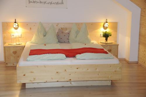 a bedroom with a wooden bed with two night stands at Branntweineralm in Tamsweg