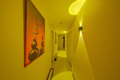 a hallway with a room with a painting of vases on the wall at The Green Park Bostancı in Istanbul