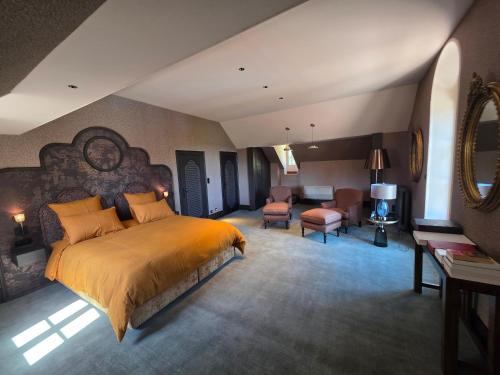 a bedroom with a large bed and a living room at Domaine des Chailloux in Jully-lès-Buxy