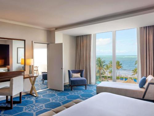 a hotel room with a bed and a desk and a desk at Fairmont El San Juan Hotel in San Juan