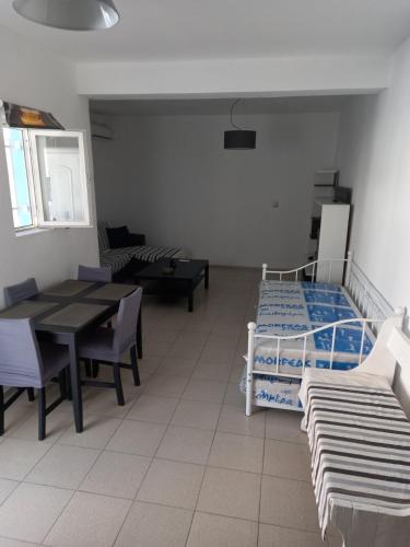 a hospital room with a bed and tables and chairs at Apartment PAPAS in Mastihari