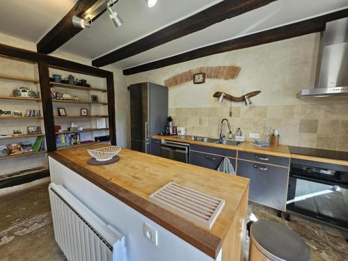 a large kitchen with a counter and a sink at Gite le rémijour in Céaux-en-Couhé