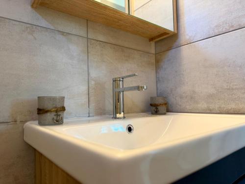 a white sink in a bathroom with a mirror at Themis in Aghia Marina