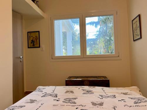 a bedroom with a bed and a window at Themis in Aghia Marina