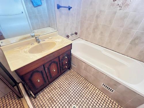 a bathroom with a sink and a bath tub at Room51 in Sydney