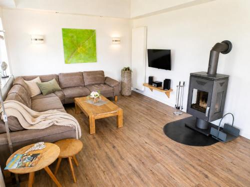 a living room with a couch and a fireplace at Reetdachhaus 1, inkl 2 Parkplätze in Fehmarn