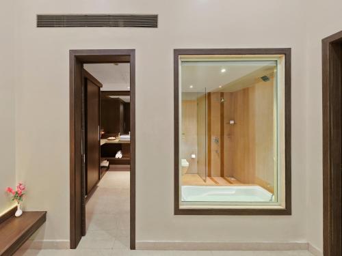a bathroom with a mirror and a walk in shower at Tropical Retreat By Zuper in Igatpuri