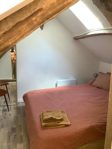 a bedroom with a bed with a red blanket at Longère au Numéro 7 in Le Tronquay