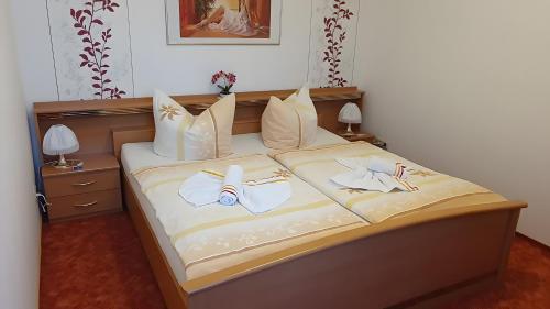 a bedroom with a bed with two towels on it at Ferienwohnung 1 in Bad Wilsnack