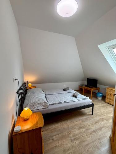 a bedroom with a bed and a table in a room at Kékkúti Apartman in Kékkút