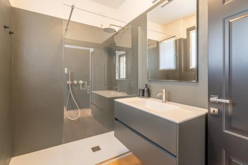 a bathroom with a sink and a shower at Lake Como View 3BR Regina 35 in Carate Urio
