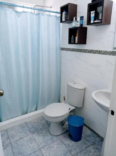 a bathroom with a toilet and a shower and a sink at La Milagrosa in Caracas