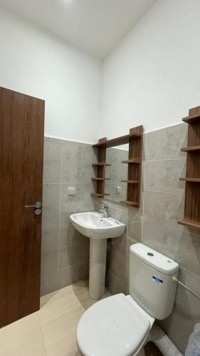 a bathroom with a toilet and a sink at Exclusive Modern Garden Flat ,Marrakech in Marrakesh