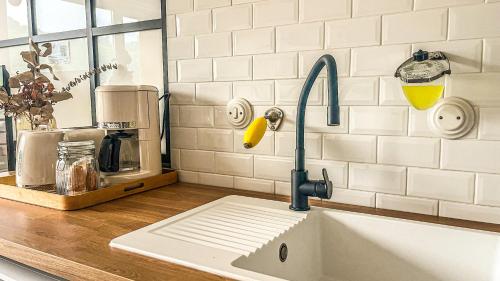 a kitchen sink with a faucet on a counter at Balcon Vue Panoramique - Parking - Gare 200m in Vienne