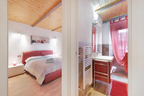 a bedroom with a bed and a sink at Prima Del Cielo - Alba Apartment in Perledo