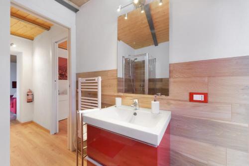 a bathroom with a white sink and a mirror at Prima Del Cielo - Alba Apartment in Perledo