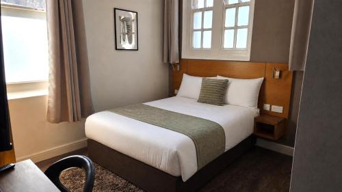 a hotel room with a bed and a window at Park Hotel & Apartments in Hull