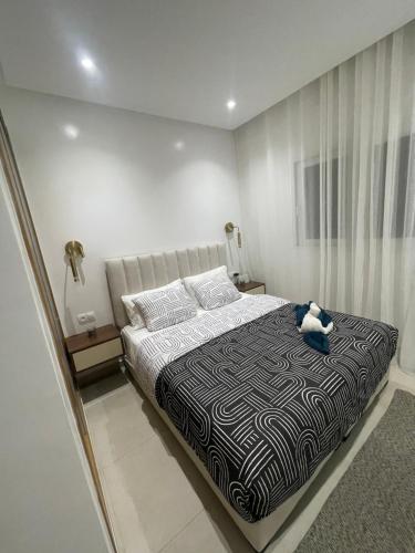 a bedroom with a bed with a teddy bear on it at Appartement suite in Cabo Negro