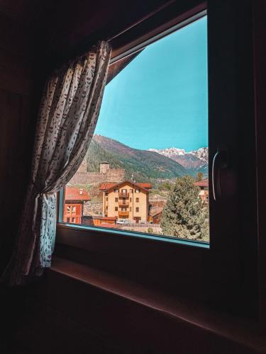 a window with a view of a mountain at Mansarda Il Castello in Ossana
