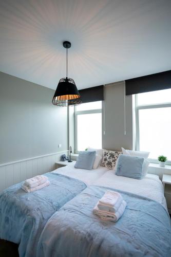 a bedroom with a large bed with two towels on it at Enjoy Today Panoramic House Koppenberg in Oudenaarde