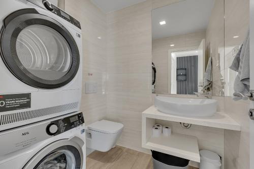a bathroom with a washing machine and a sink at Villa Prestige in Baška Voda