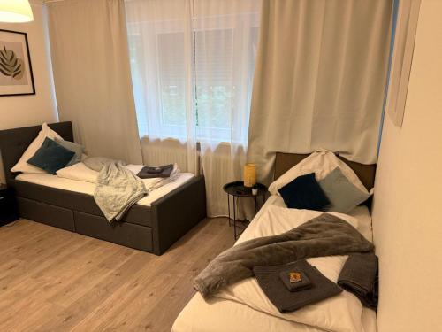 a room with two beds and a window at Schönes Apartment in Top-Lage Karlsruhe in Karlsruhe