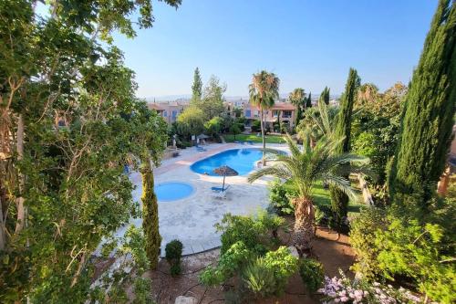 an overhead view of a swimming pool with palm trees at Mandria Gardens Paradise II in Mandria