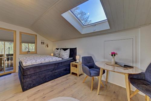 a bedroom with a bed and a table and chairs at Landhaus Melch in Zwiesel