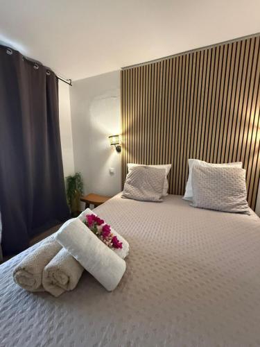 a hotel room with a bed with towels and flowers on it at Ti Kaz Paradise in Le Diamant