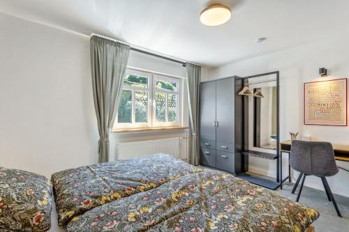 a bedroom with a bed and a desk and a window at Apartment Burgquartier in Schmallenberg