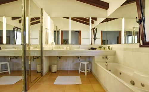 a bathroom with two sinks and a tub and a shower at Sa Font den Ros Mallorca in Son Servera