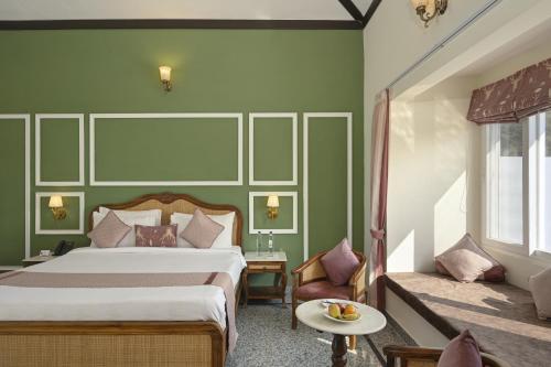 a hotel room with a bed and a couch at Trulyy The Jawai Leopard Kingdom in Jāmb