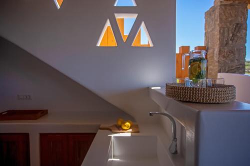 a kitchen with a white refrigerator and a staircase at Mystic Horizon in Mikonos