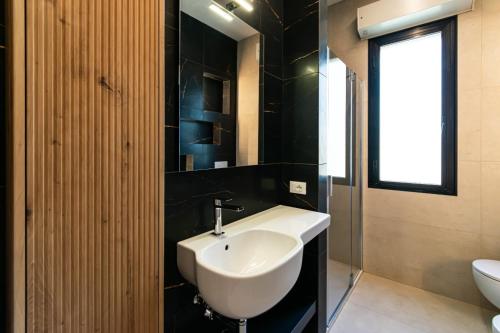 a bathroom with a white sink and a toilet at Residence Caterina in Cattolica