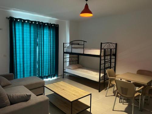 a living room with two bunk beds and a table at Apartments Kristi in Shëngjin