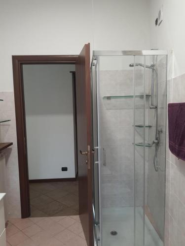a shower with a glass door in a bathroom at B&B Luna in Sesto Calende