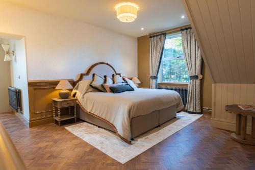 a bedroom with a large bed and a window at Bowburn Hall Hotel in Durham