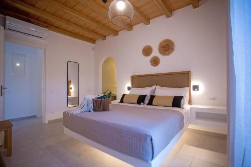 a bedroom with a large bed in a room at Mystic Horizon in Mikonos