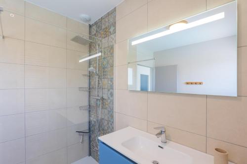 a bathroom with a sink and a mirror at Villa Lisa in Balazuc