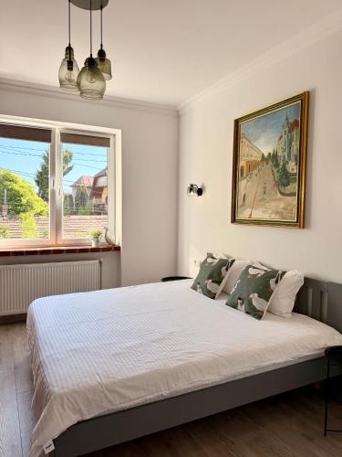 a bedroom with a bed and a painting on the wall at Федорцьо in Mukacheve