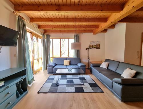 a living room with a couch and a table at Haus 16 im Natur Ferienpark, Natur, Abenteuer und Entspannung für unvergessliche Urlaubstage in Nieheim