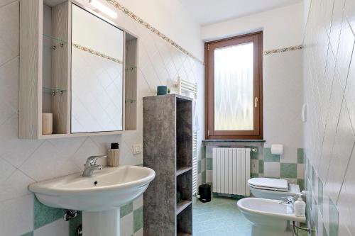 a bathroom with a sink and a toilet at Casa Alessandra in Torri del Benaco